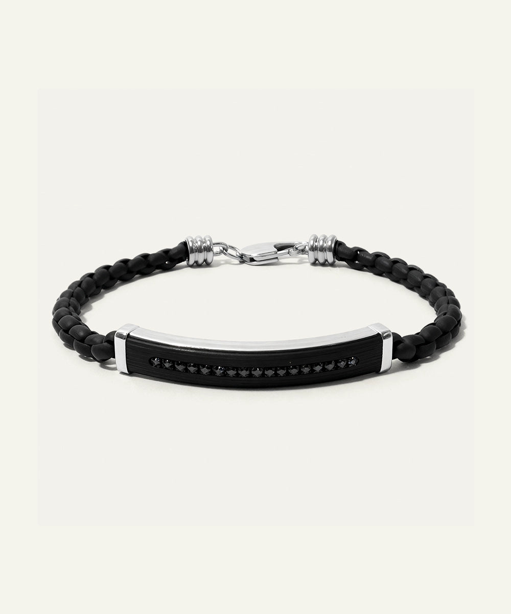 Black braided bracelet with a metal tag on a white background