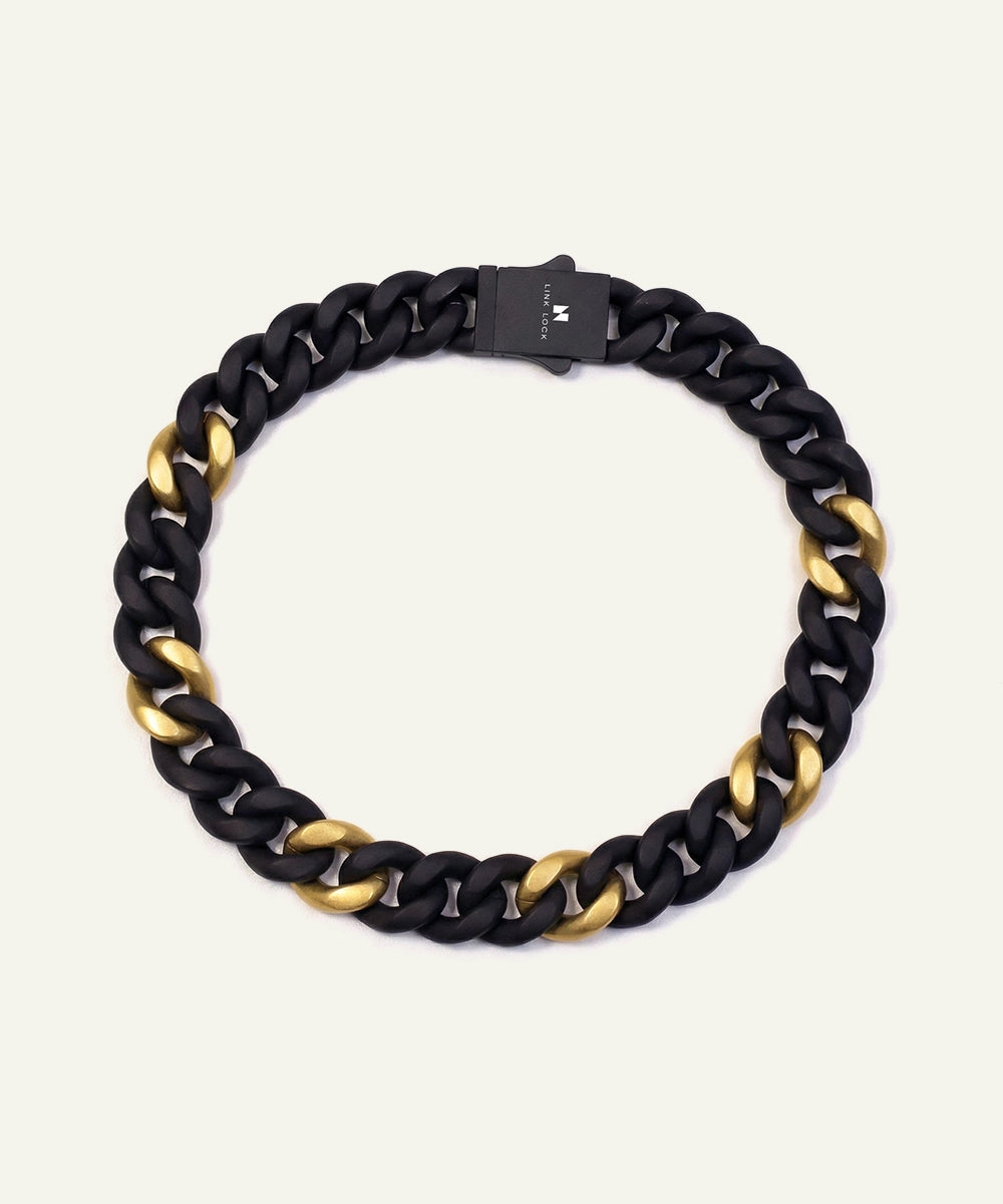 Black and gold chain necklace on a white background