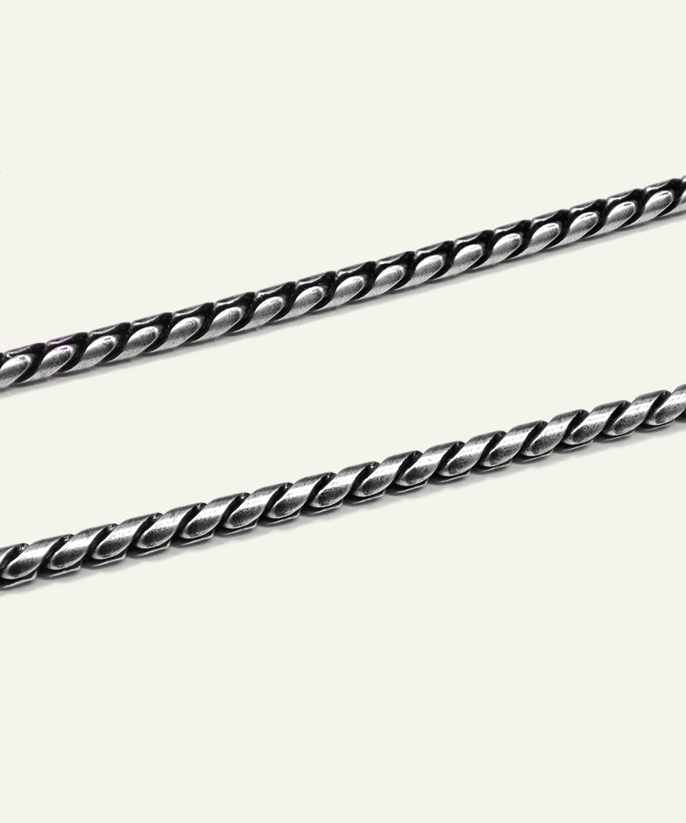 Silver chain on a light gray background