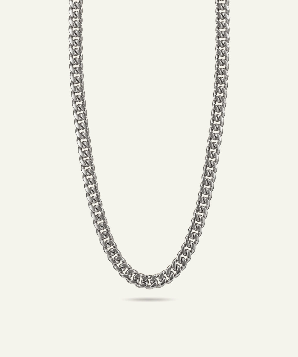 Silver chain necklace on a light gray background