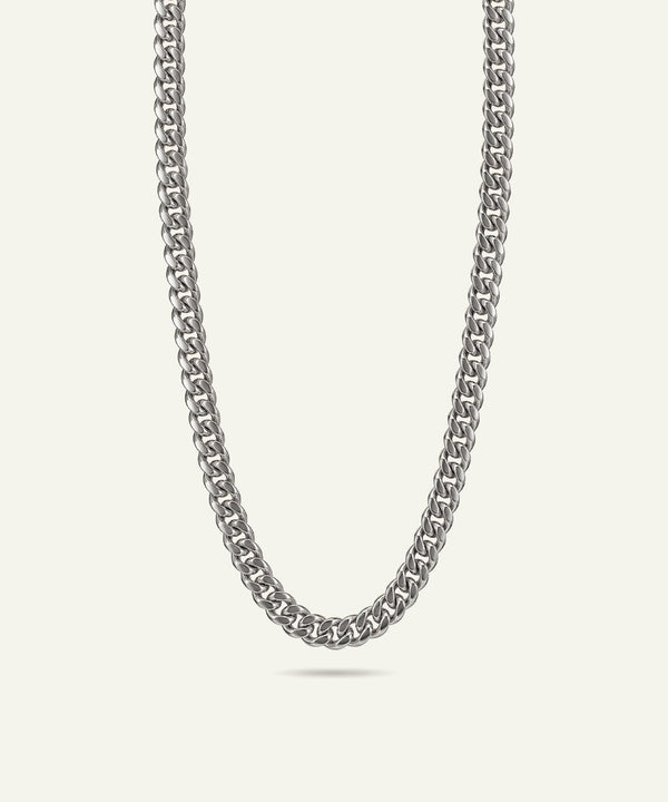 Silver chain necklace on a light gray background
