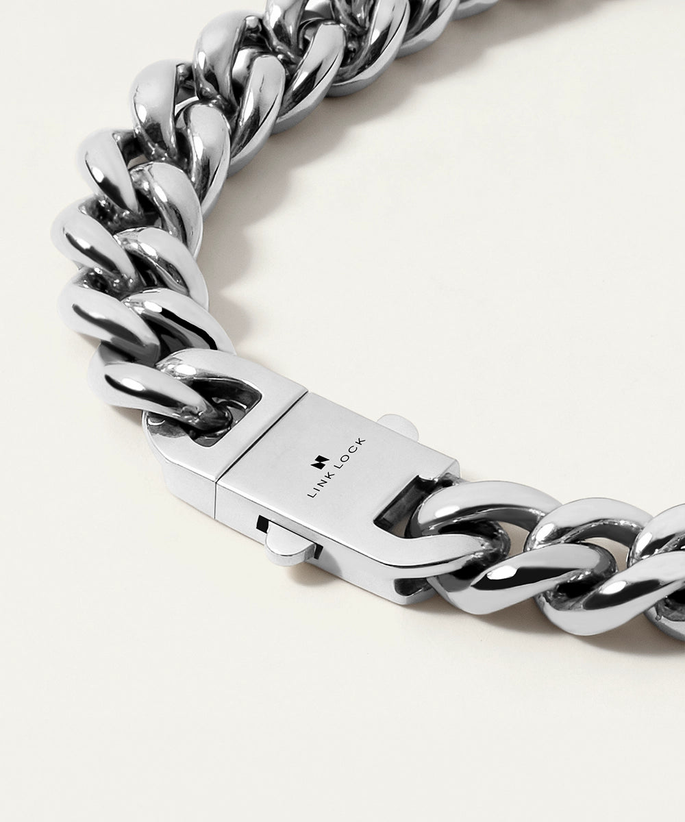 Silver chain bracelet with a clasp on a light background