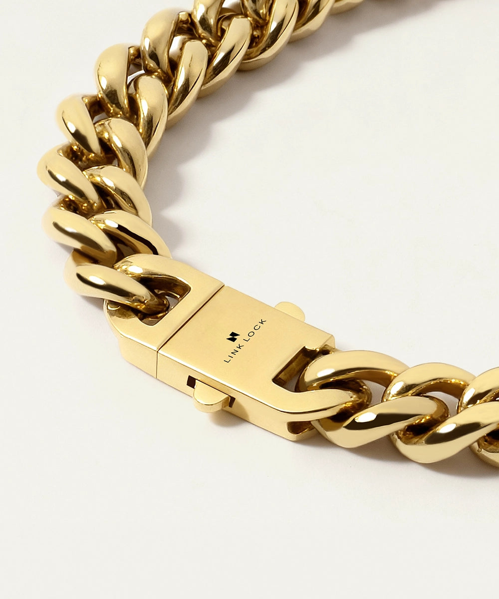 Gold chain bracelet with a clasp on a white background