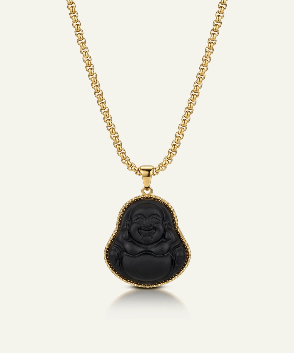 Black Buddha pendant on a gold chain against a white background