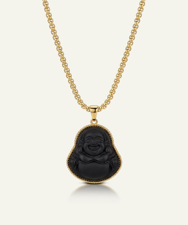 Black Buddha pendant on a gold chain against a white background
