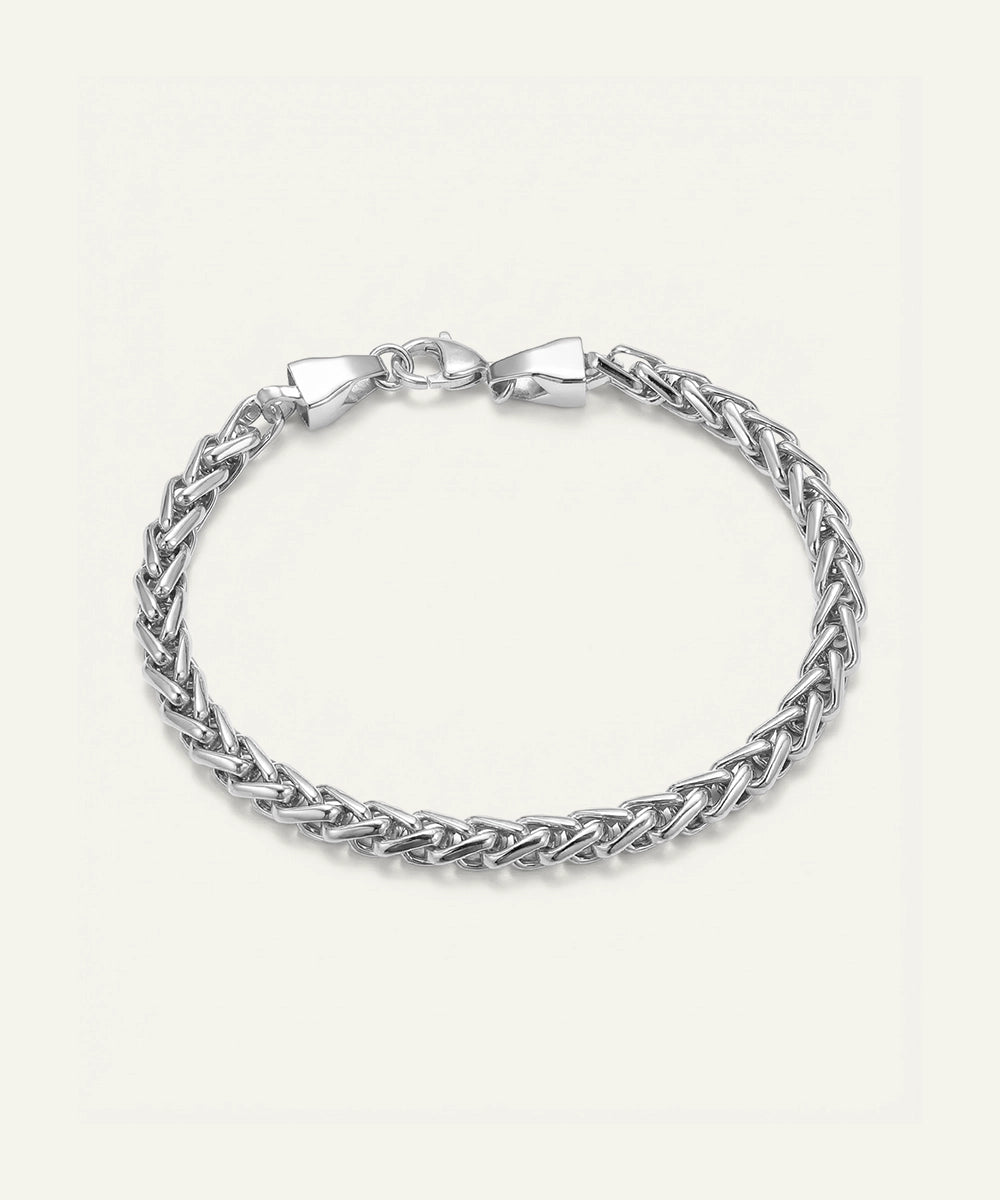 Silver braided bracelet on a light gray background