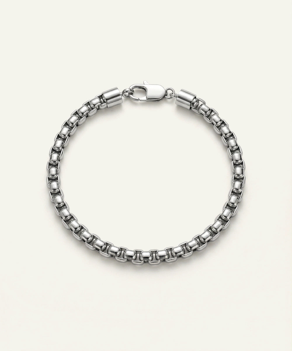 Silver bracelet on a light beige background