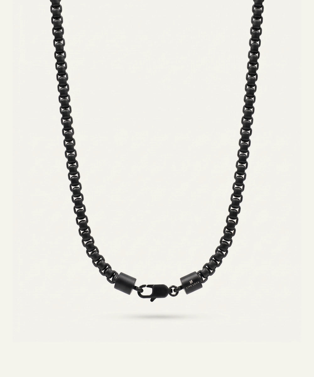 Black beaded necklace on a light gray background