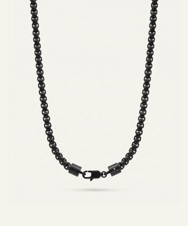 Black beaded necklace on a light gray background