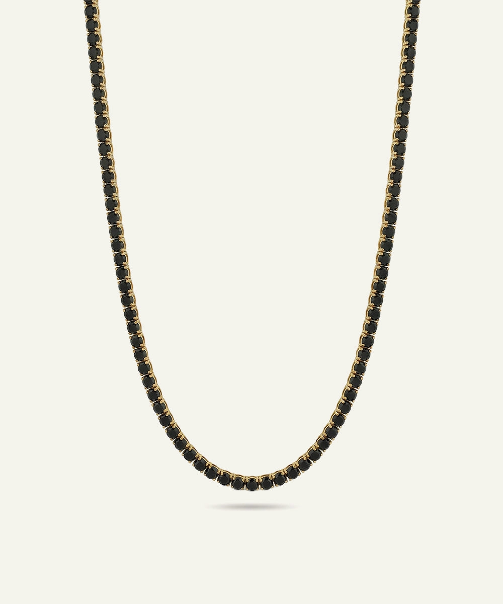 Necklace with black beads on a light gray background