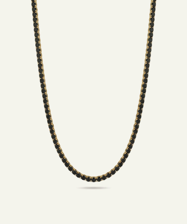 Necklace with black beads on a light gray background