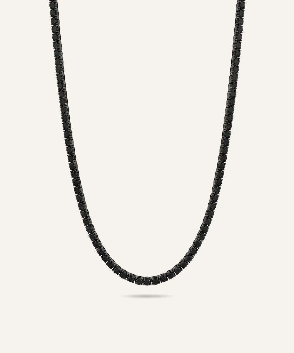 Black beaded necklace on a light gray background