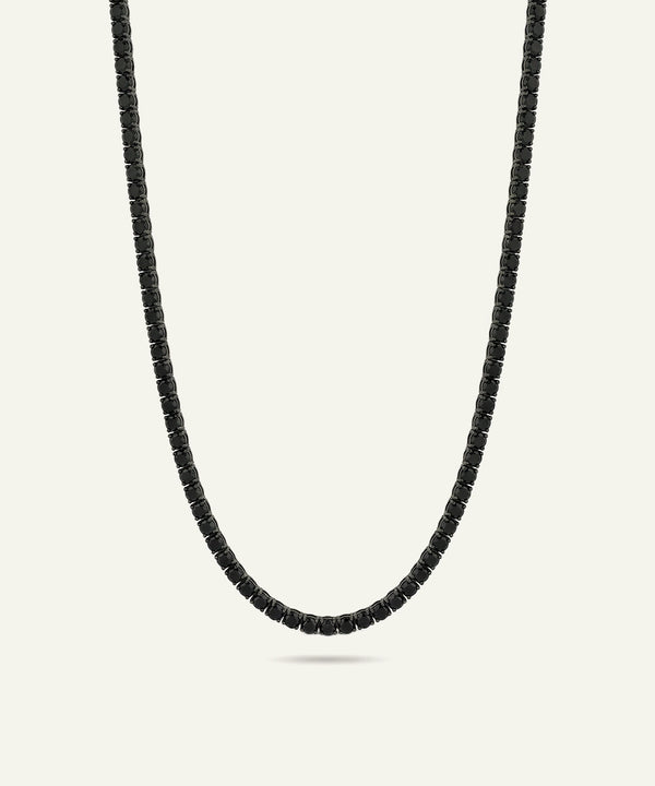 Black beaded necklace on a light gray background