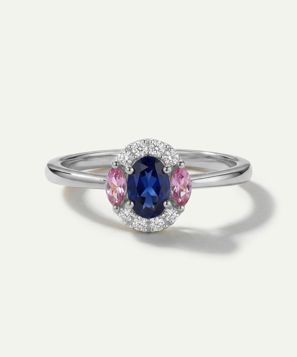 Silver ring with a blue gemstone and pink accents on a white background