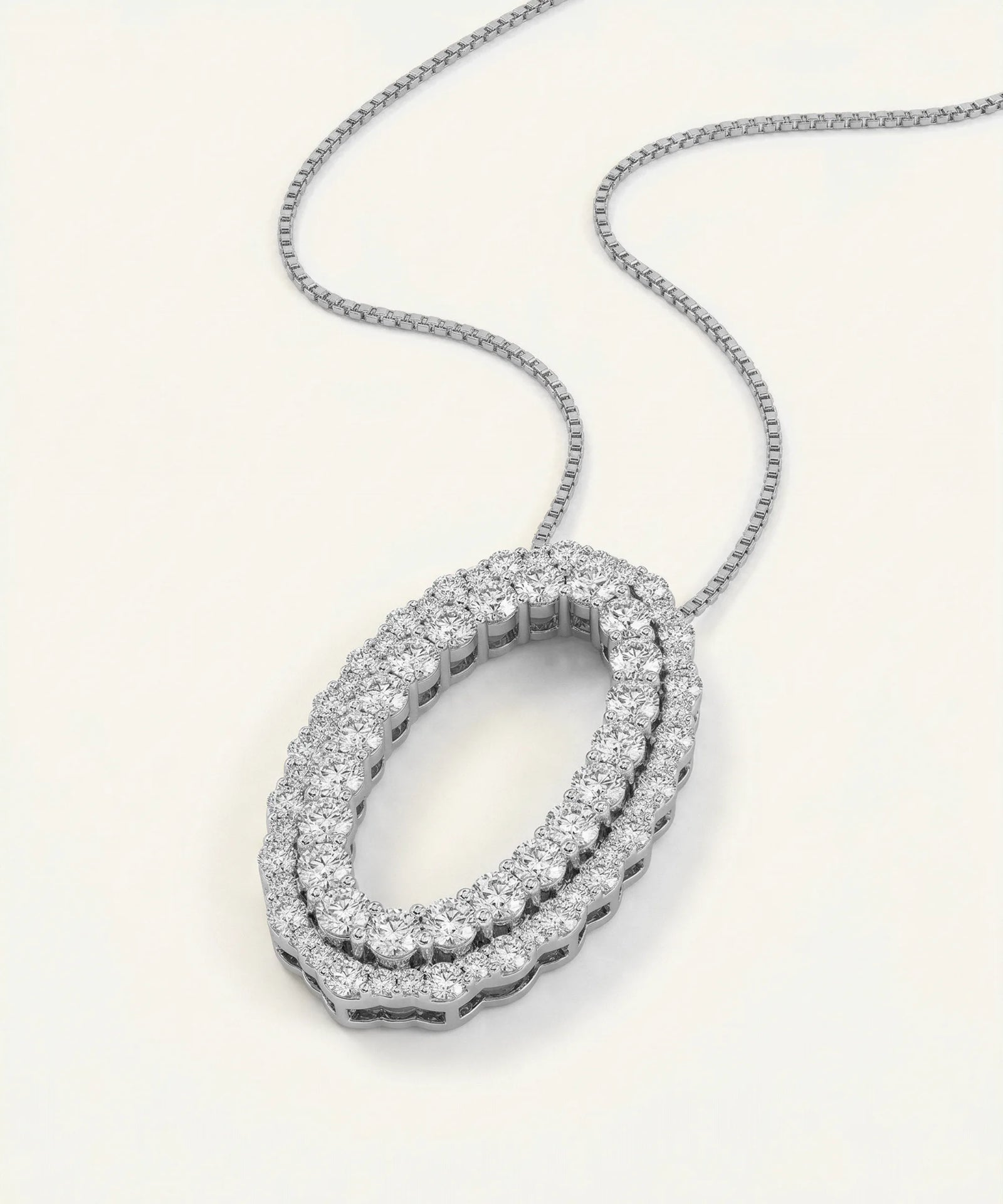 Diamond necklace with a white gold chain on a light gray background