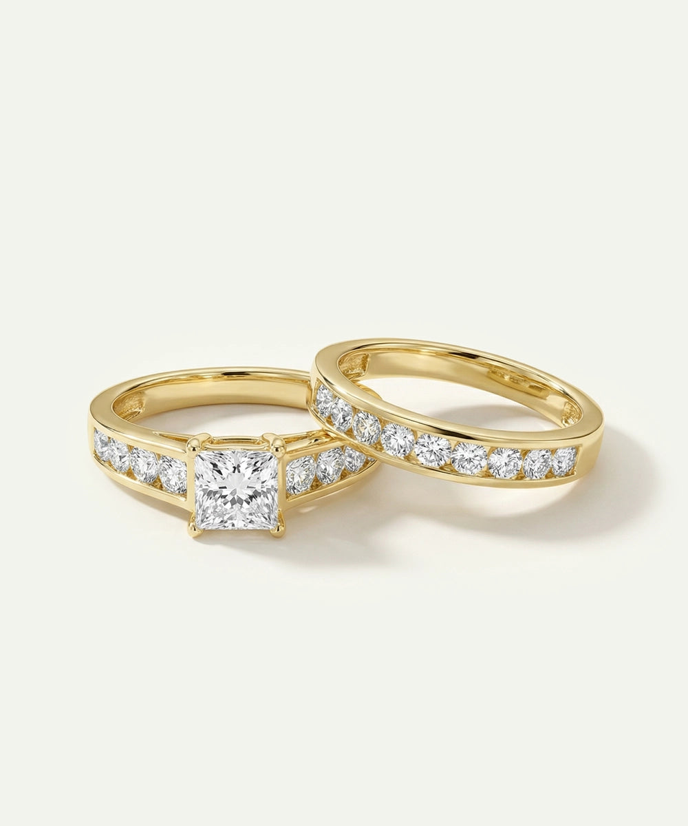 Two gold rings with diamond accents on a light gray background