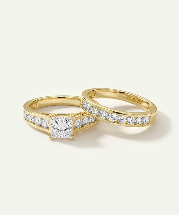 Two gold rings with diamond accents on a light gray background