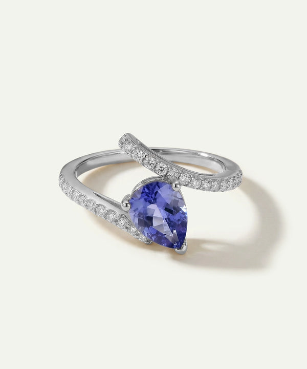 Silver ring with a purple gemstone on a white background