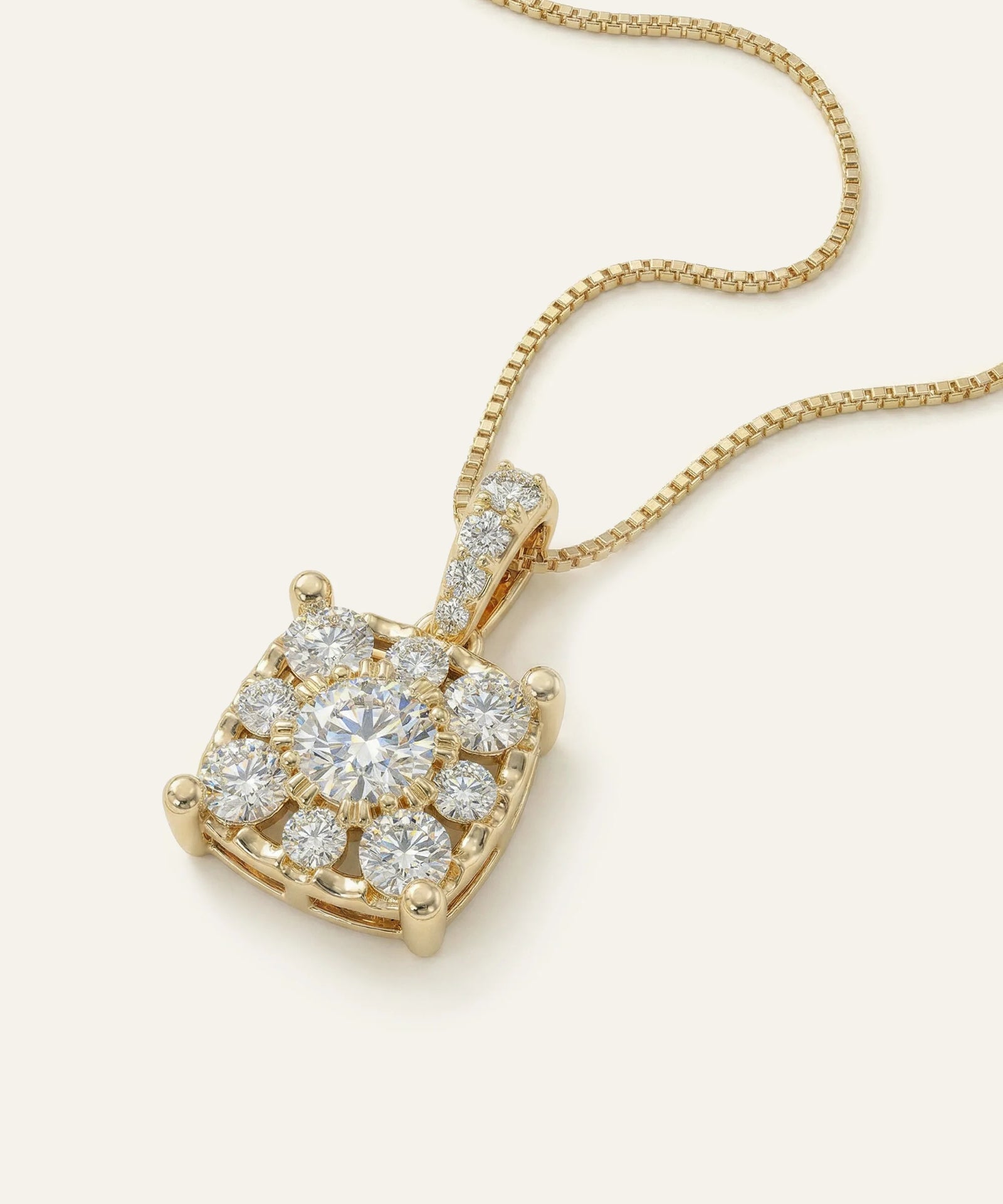 Gold necklace with a diamond pendant on a white background