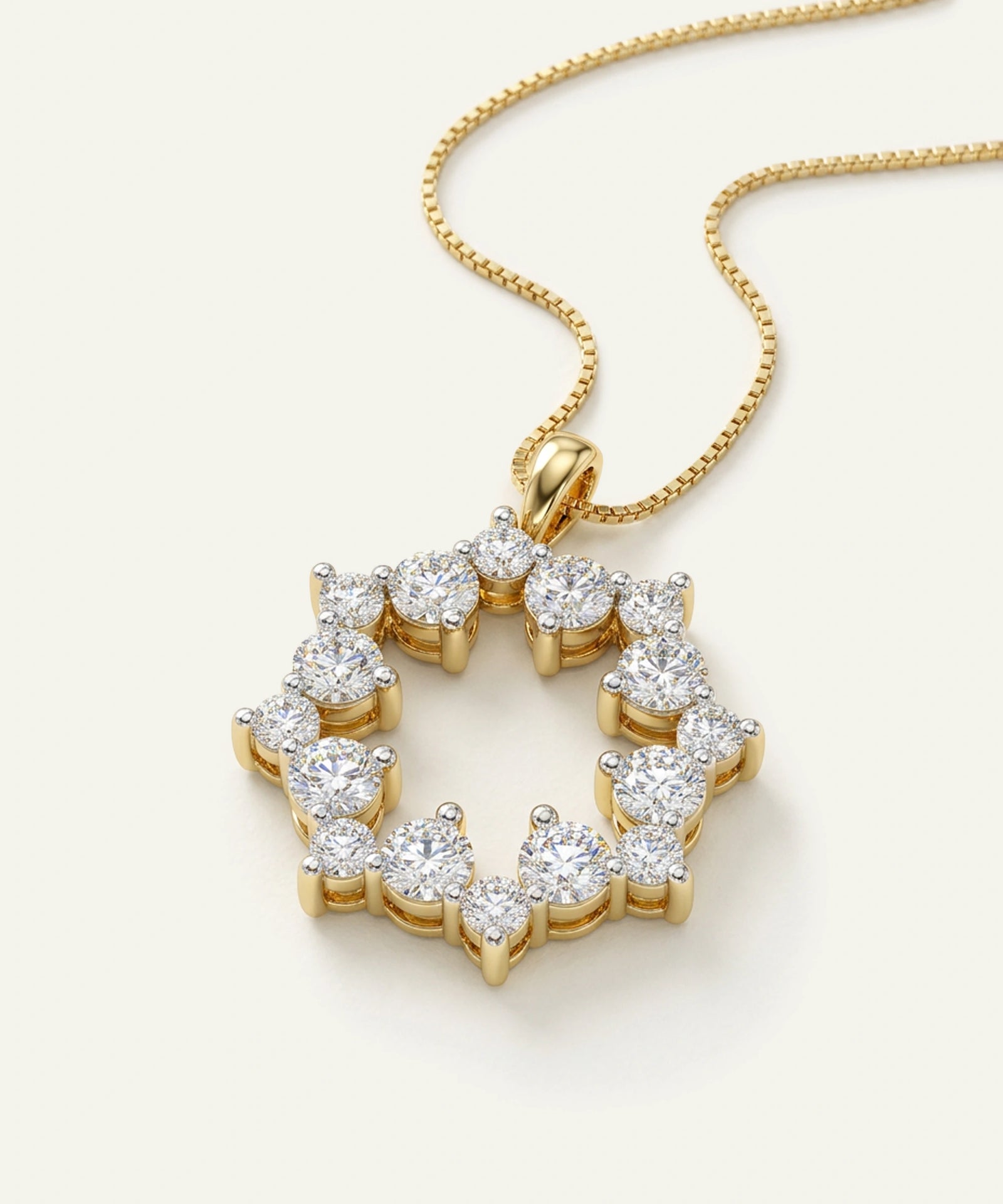 Gold necklace with a diamond pendant on a light background