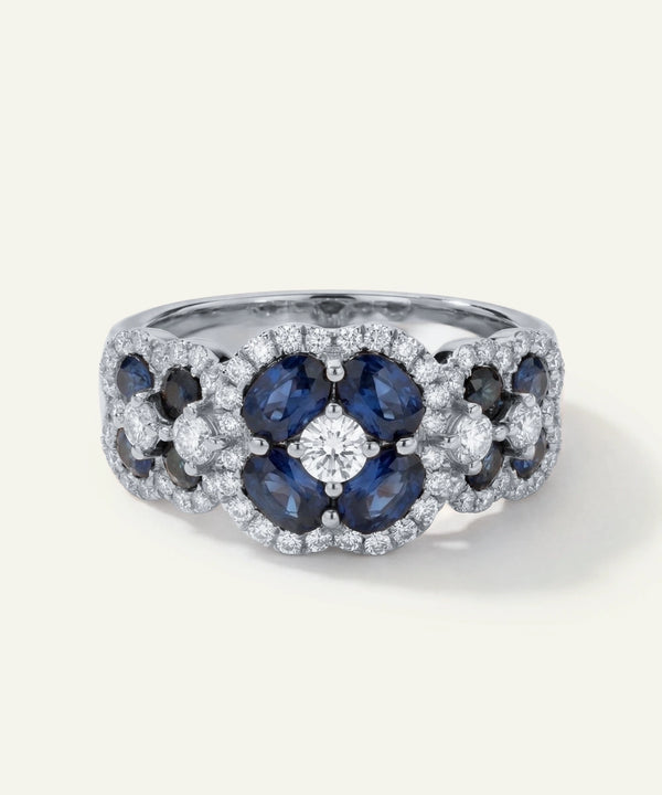 Elegant ring with blue gemstones and diamonds on a white background