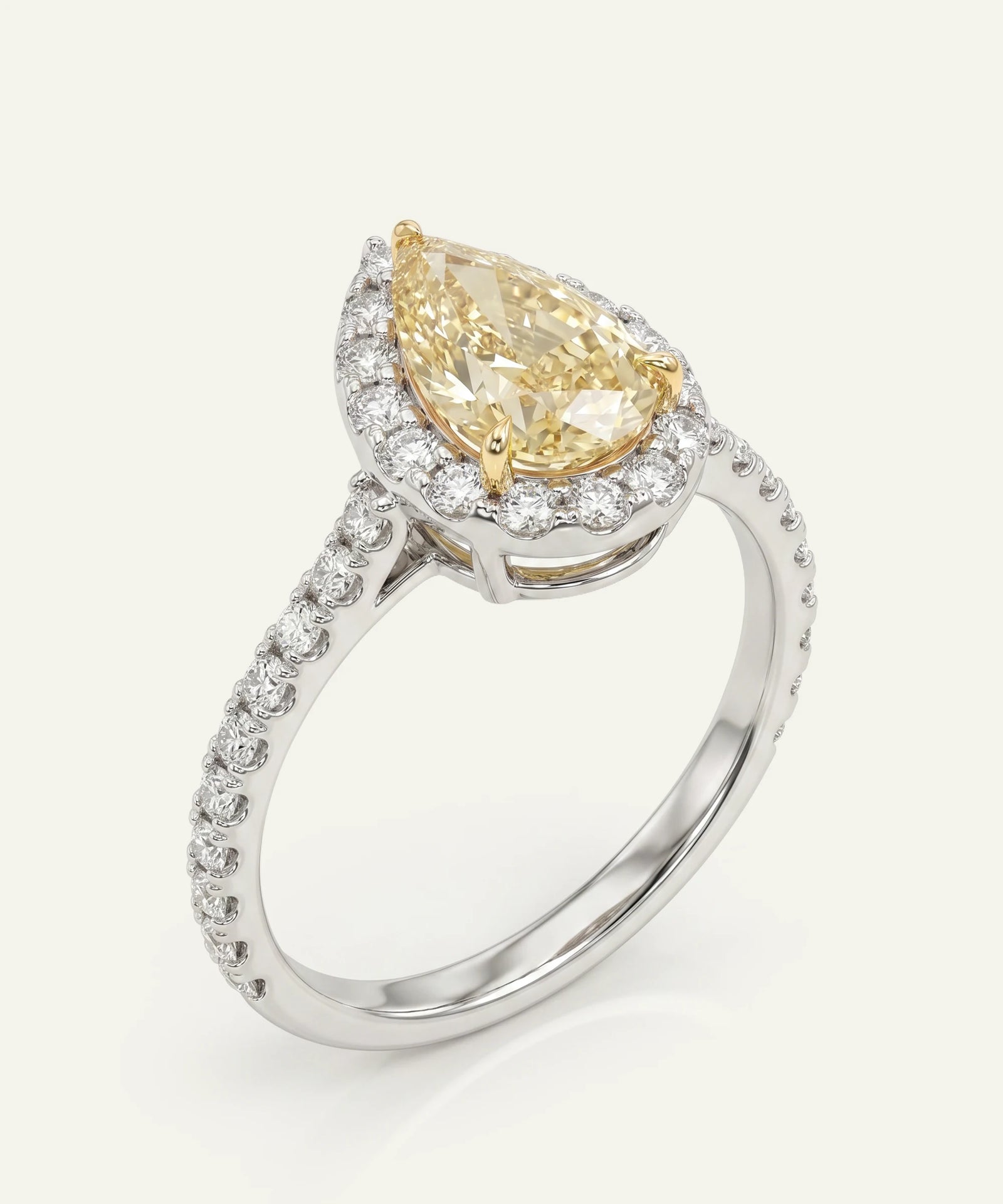 Diamond ring with a pear-shaped yellow diamond on a white background
