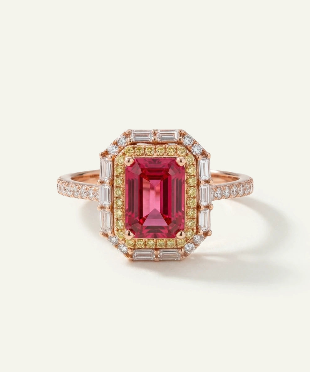 Ring with a red gemstone and gold accents on a white background