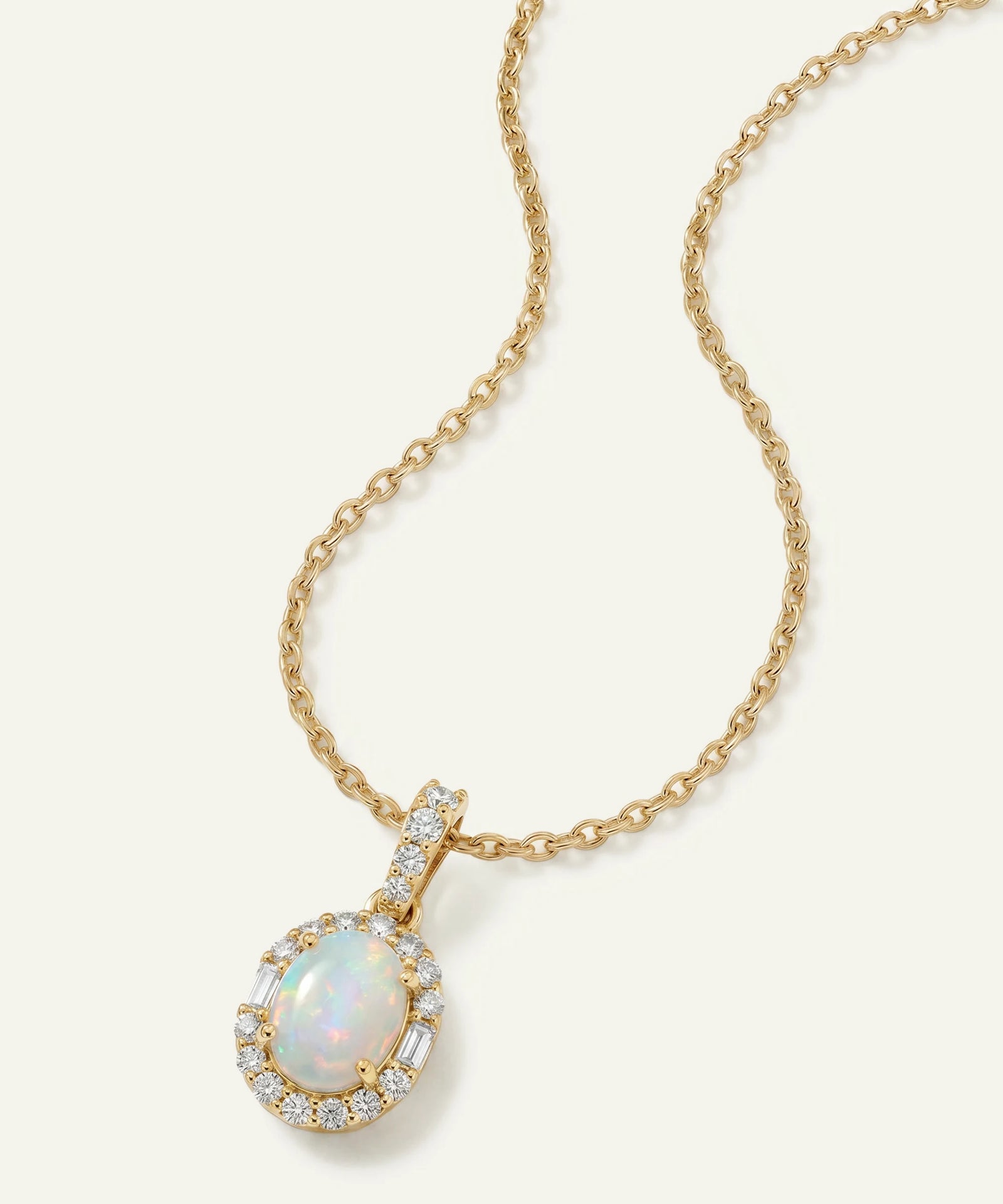 Gold necklace with an opal pendant on a white background