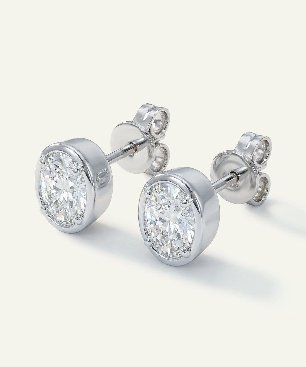 Pair of diamond stud earrings on a light gray background