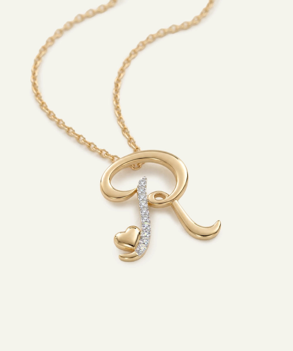 Gold necklace with an 'R' pendant on a white background