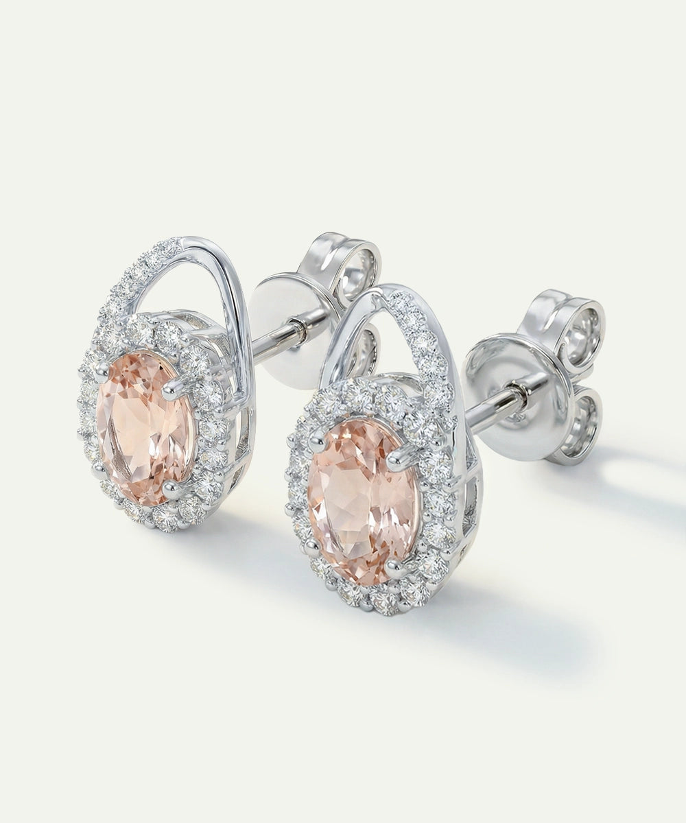 Silver earrings with pink gemstones on a white background