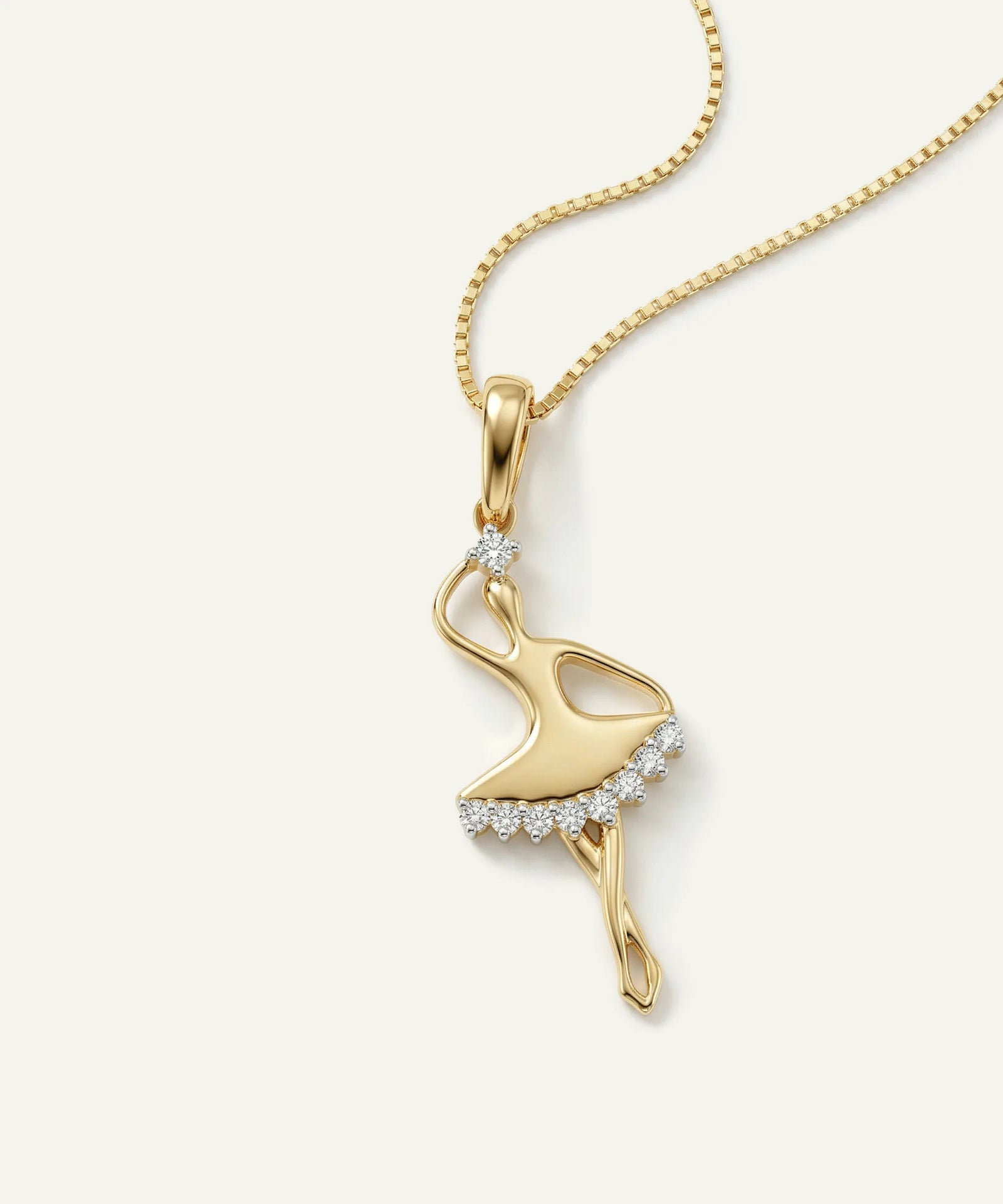 Gold flamingo pendant necklace on a white background