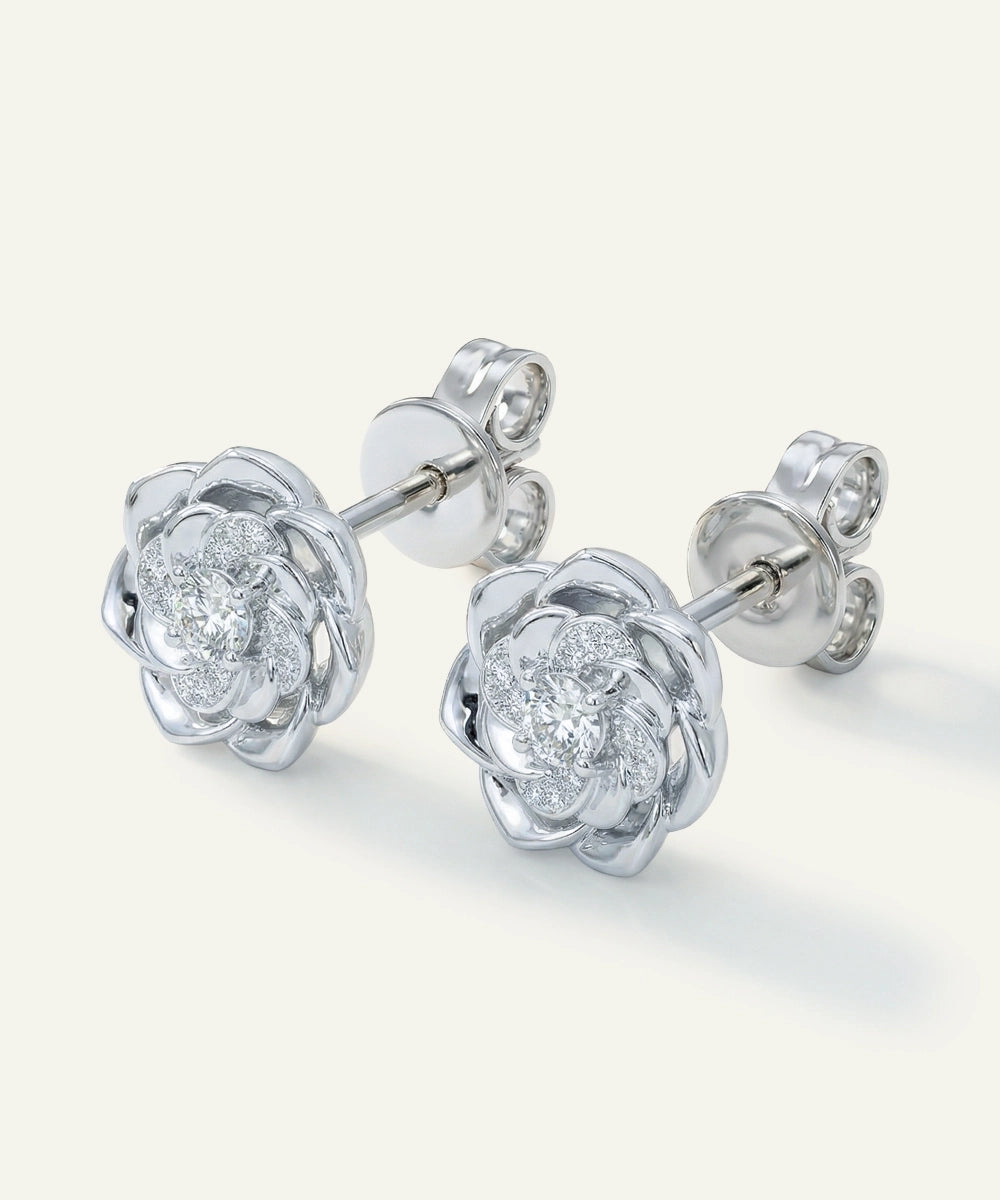 Silver earrings with floral design on a white background