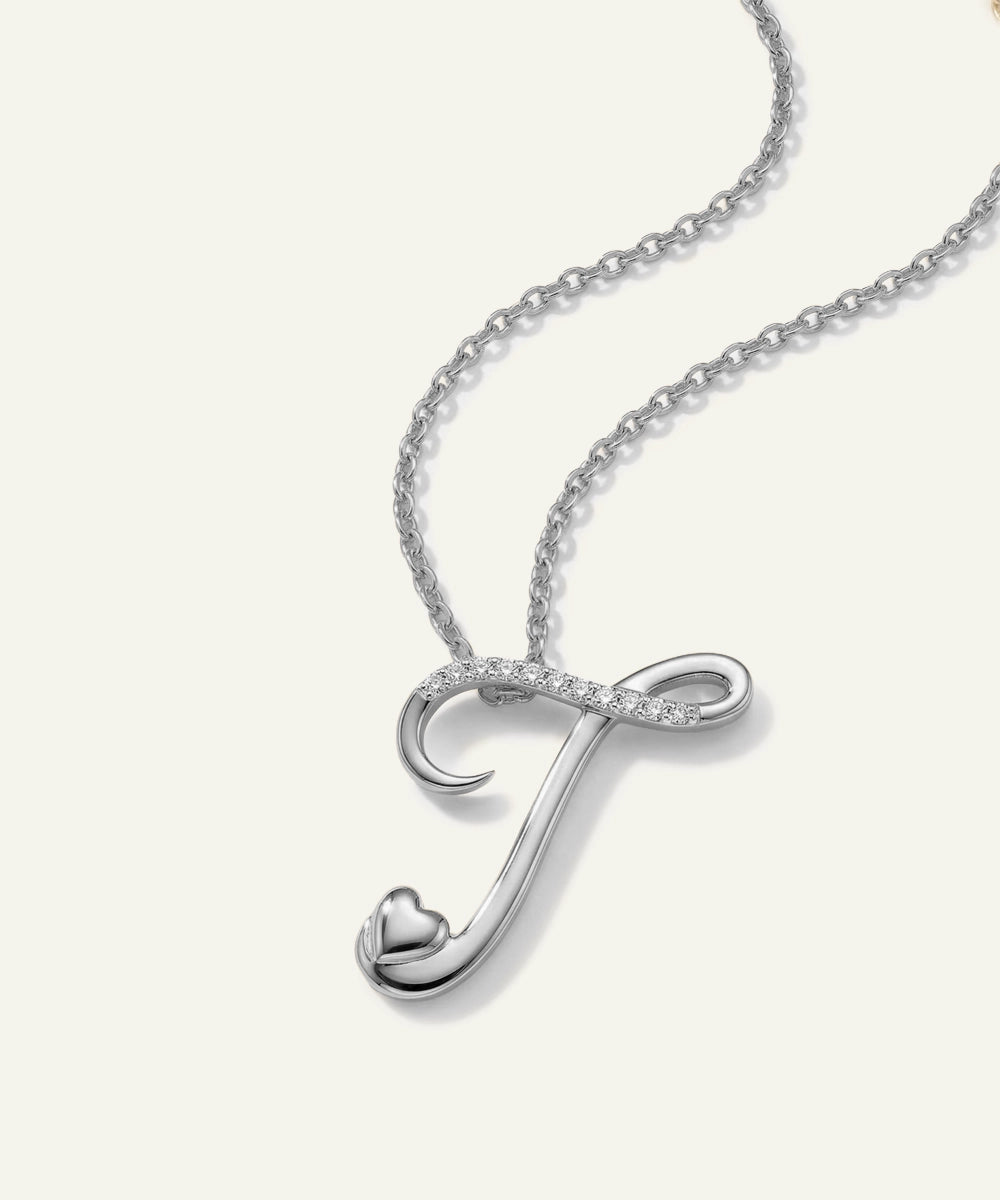 Silver necklace with a heart-shaped pendant on a white background
