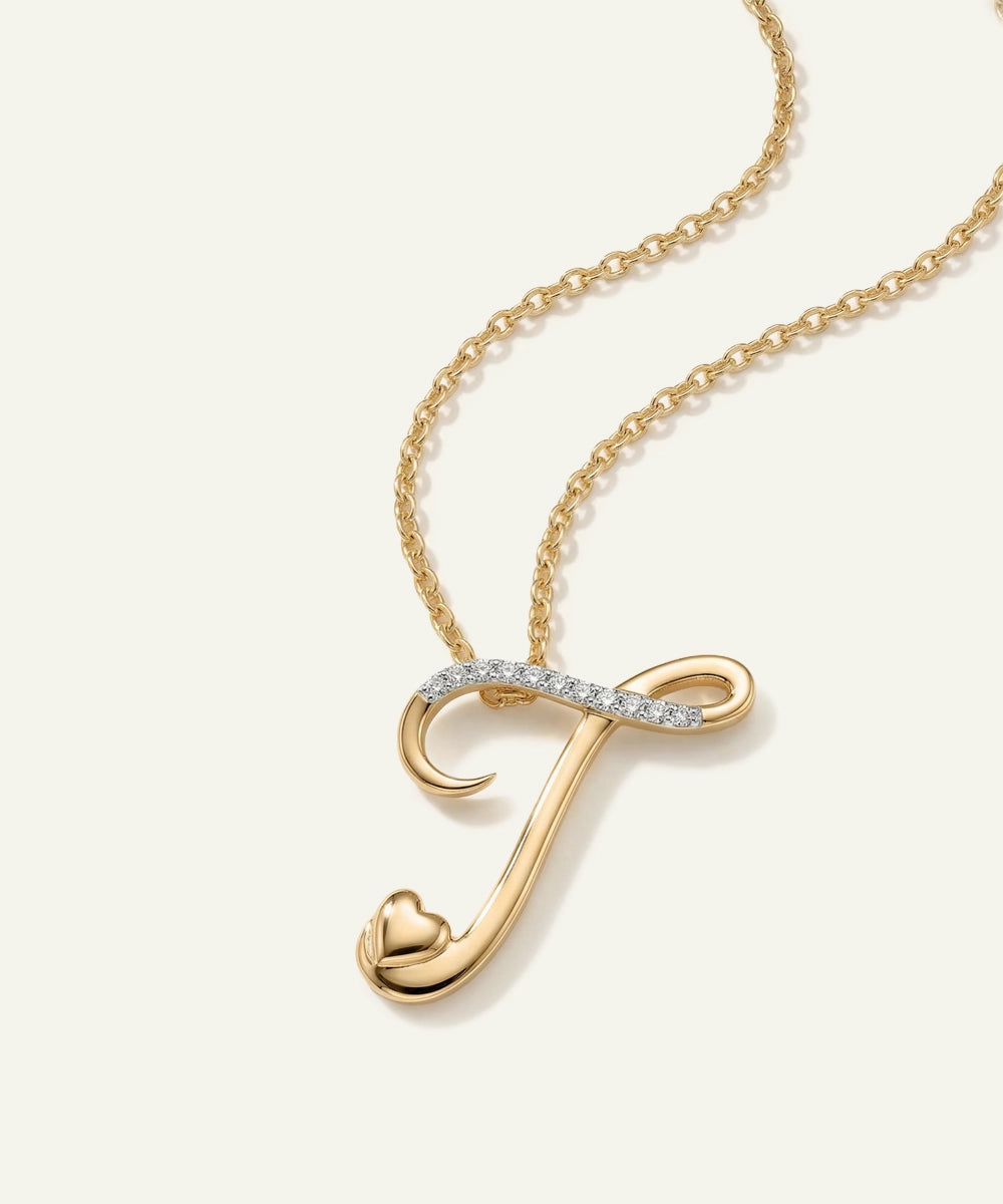 Gold necklace with a 'J' pendant on a white background