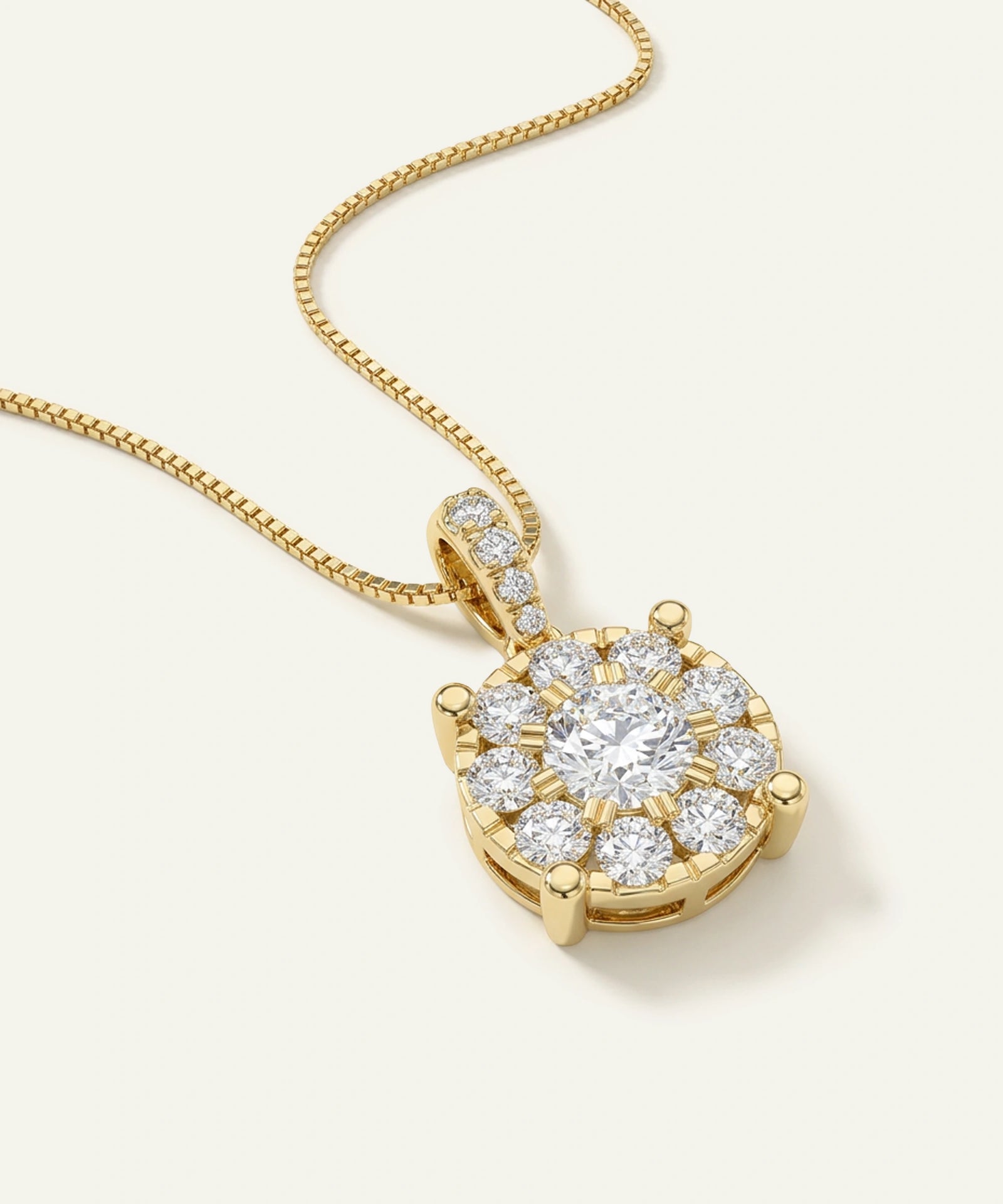 Gold necklace with a diamond pendant on a light background
