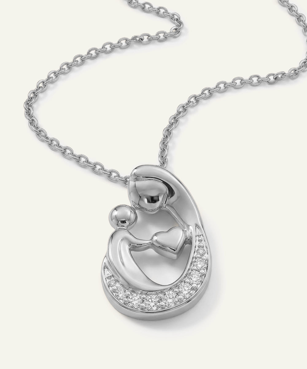Silver necklace with a heart-shaped pendant on a white background