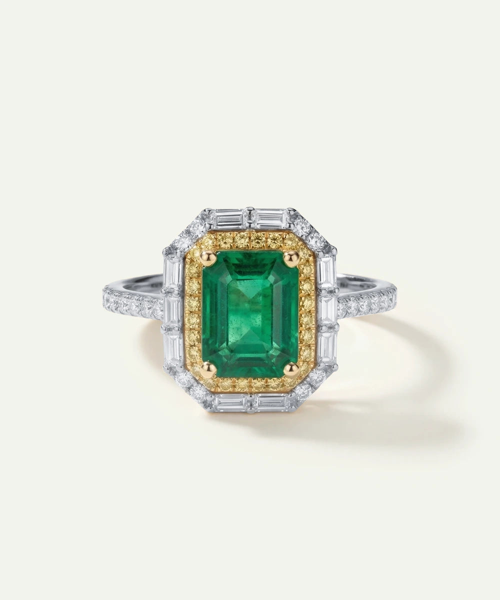 Ring with a green gemstone and gold accents on a white background