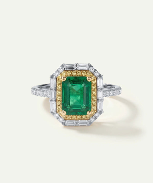 Ring with a green gemstone and gold accents on a white background