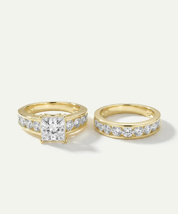 Two gold rings with diamond accents on a light gray background