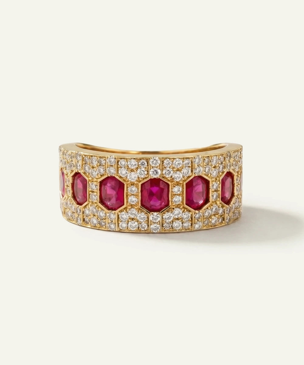 Gold bracelet with red gemstones and diamonds on a white background