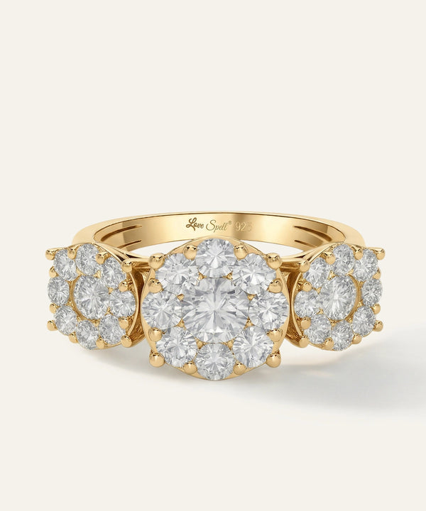 Gold ring with diamond clusters on a light beige background