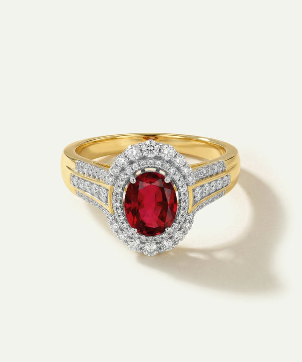 Gold ring with a red gemstone and diamond accents on a white background