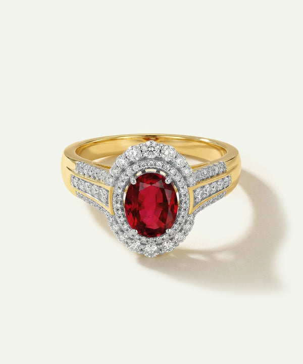 Gold ring with a red gemstone and diamond accents on a white background
