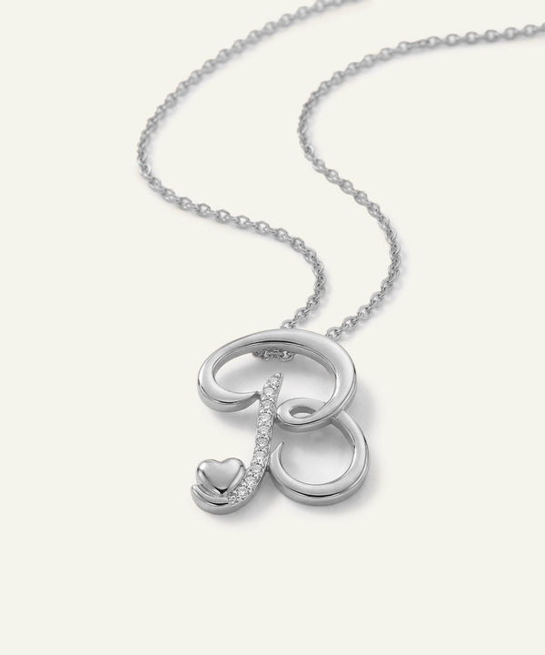 Silver necklace with a heart pendant on a white background