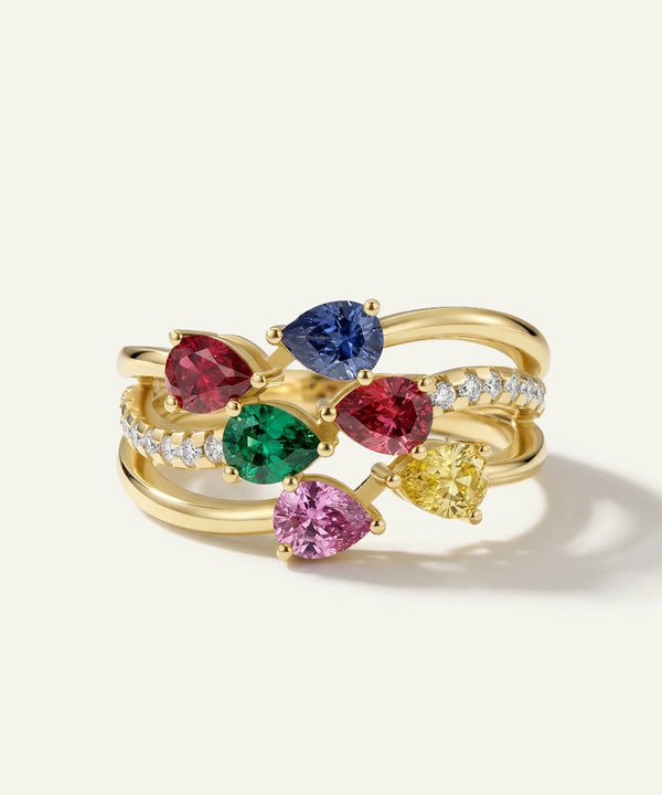 Gold ring with multicolored gemstones on a white background