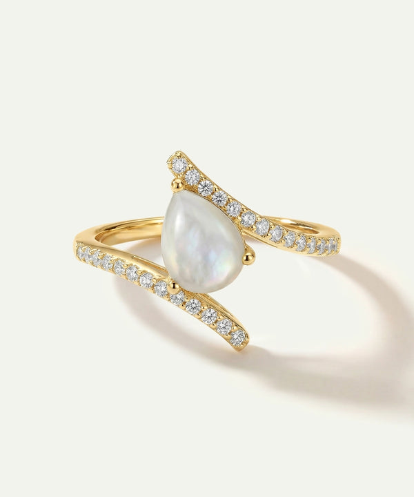 Gold ring with a pearl and small diamonds on a white background
