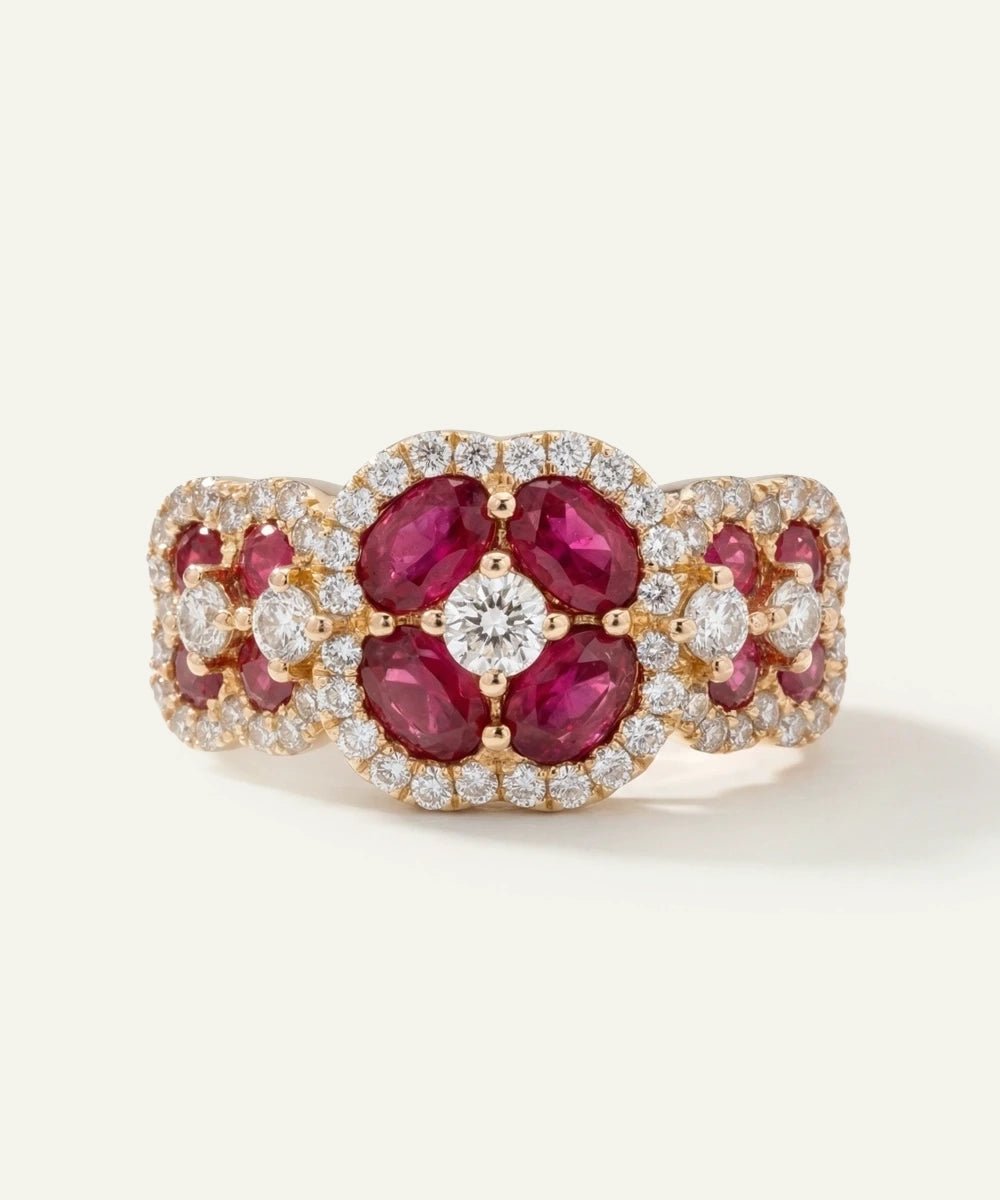 Elegant ring with red gemstones and diamonds on a white background
