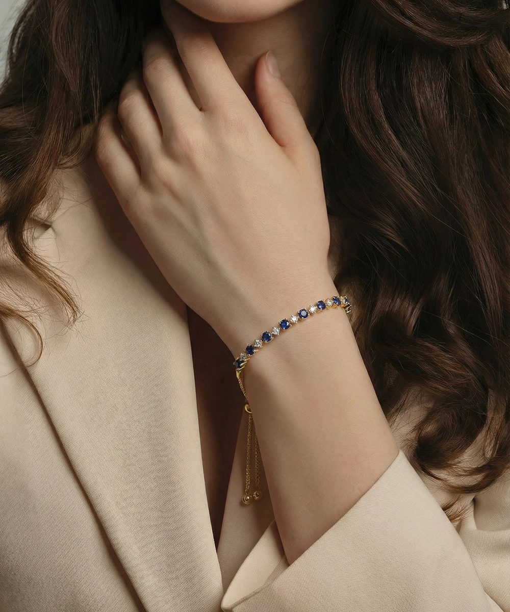Close-up of a person wearing a bracelet with a neutral background