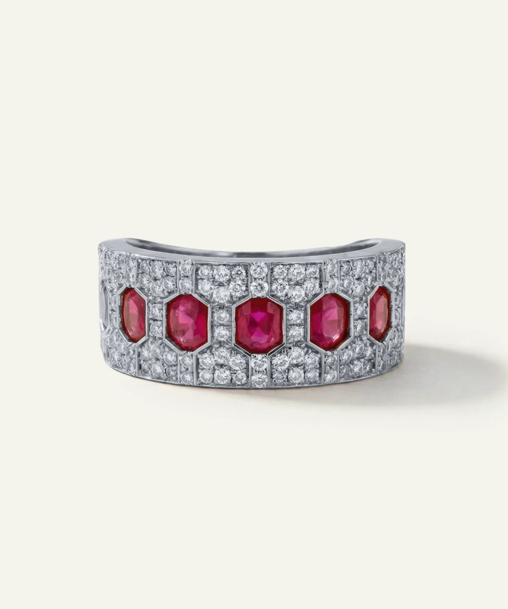 Gold bracelet with red gemstones and diamonds on a white background